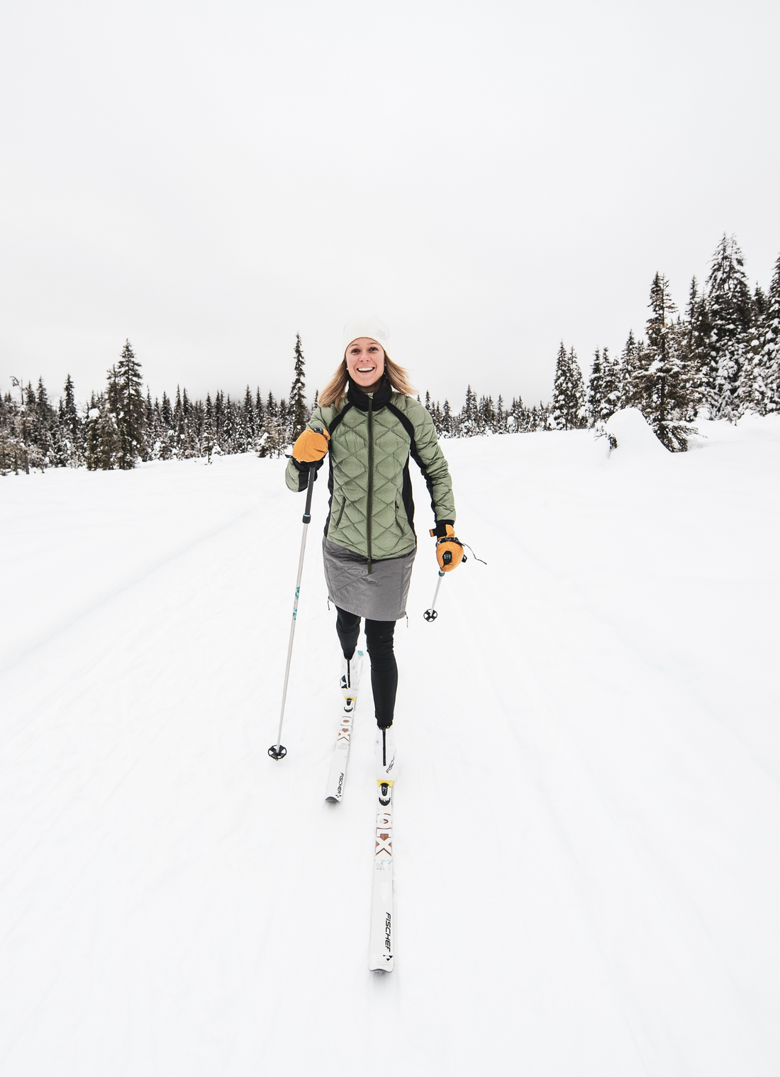woman xc skiing wearing a puffy skhoop jacket and skirt