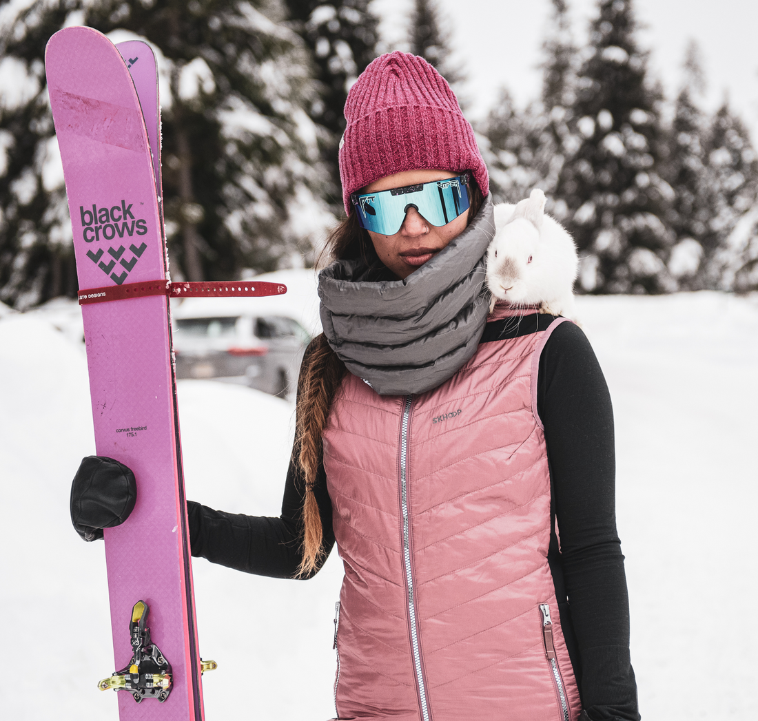 woman standing with her skis wearing down infinity scarf from skhoop