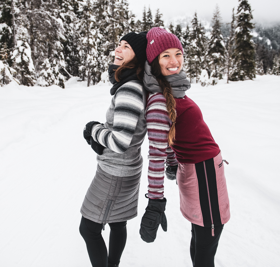 two women standing back to back wearing skhoop outfits