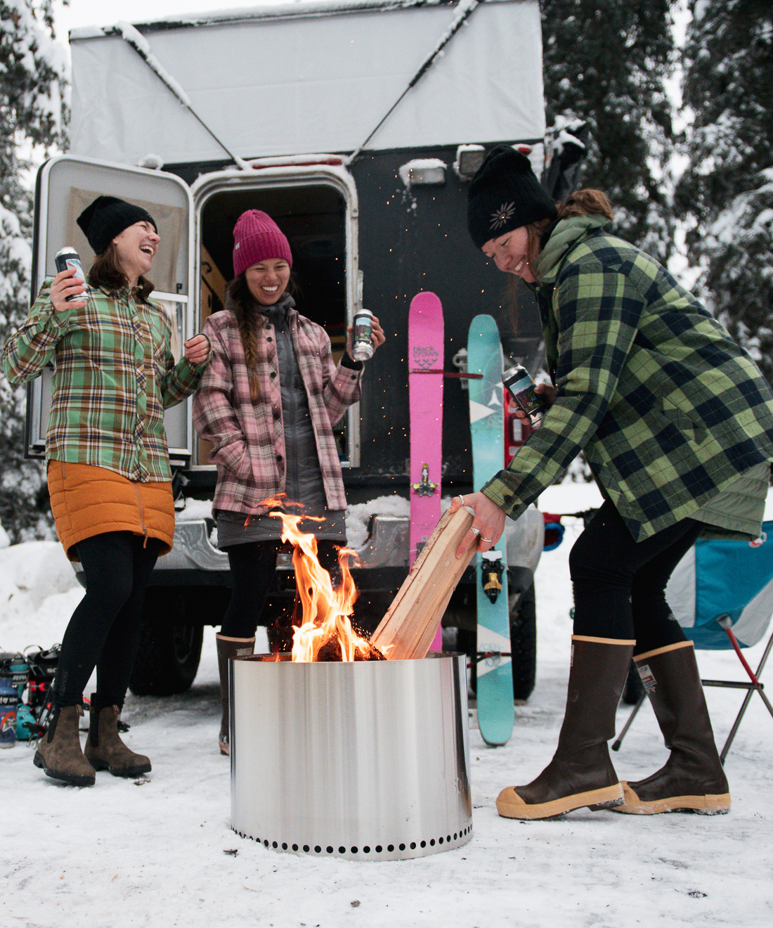 women standing around the fire in skhoop outfits