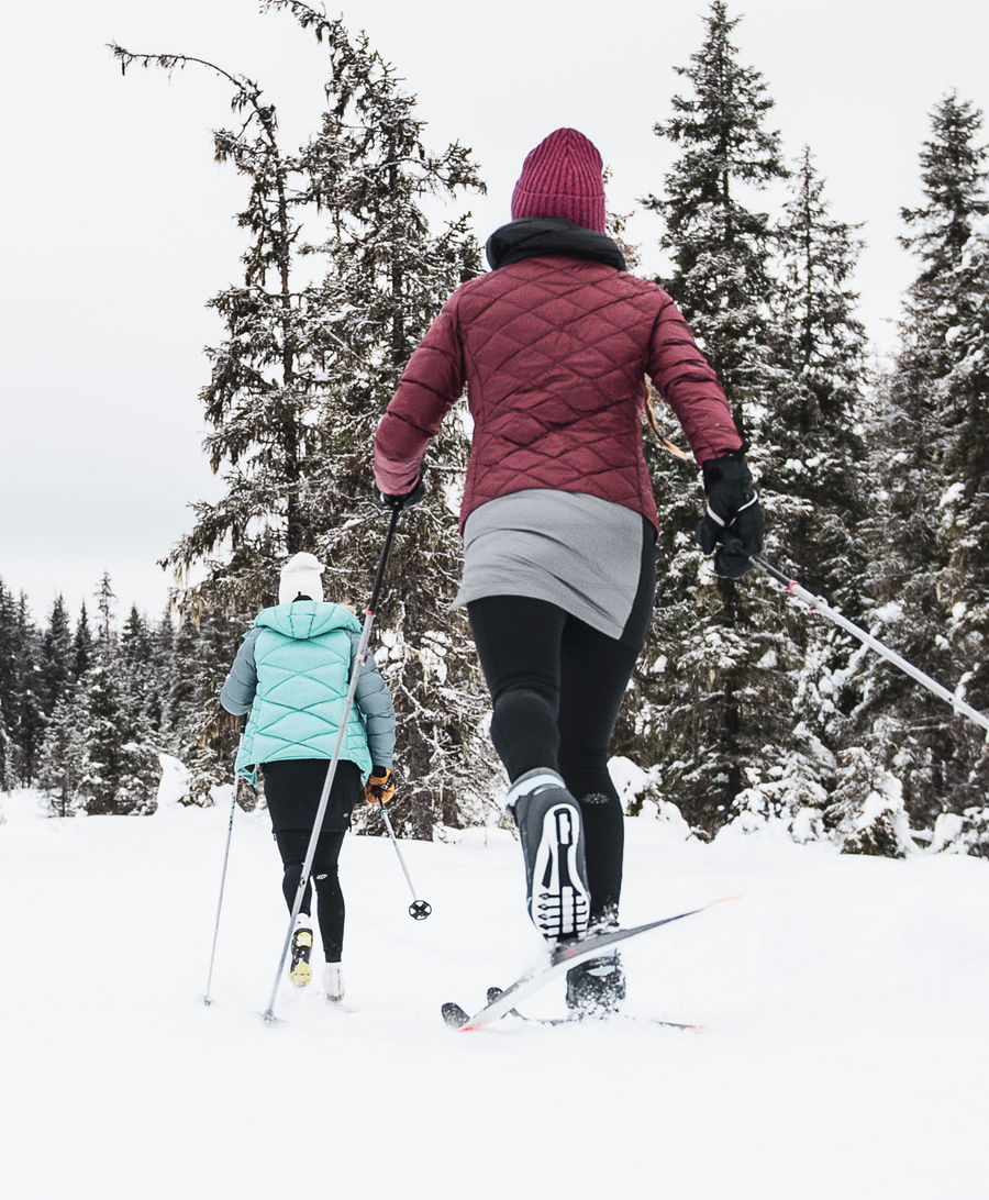 Woman skiing on a winter day in a snow skirt