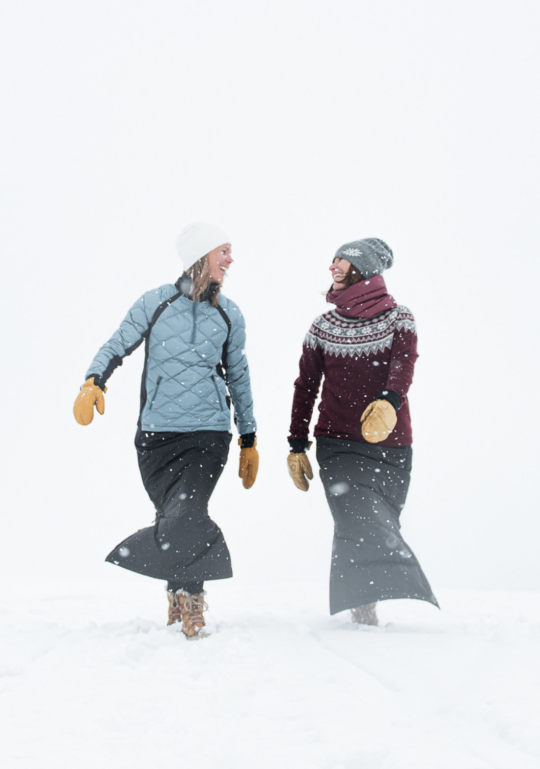 women walking in the snow wearing skhoop original beanies