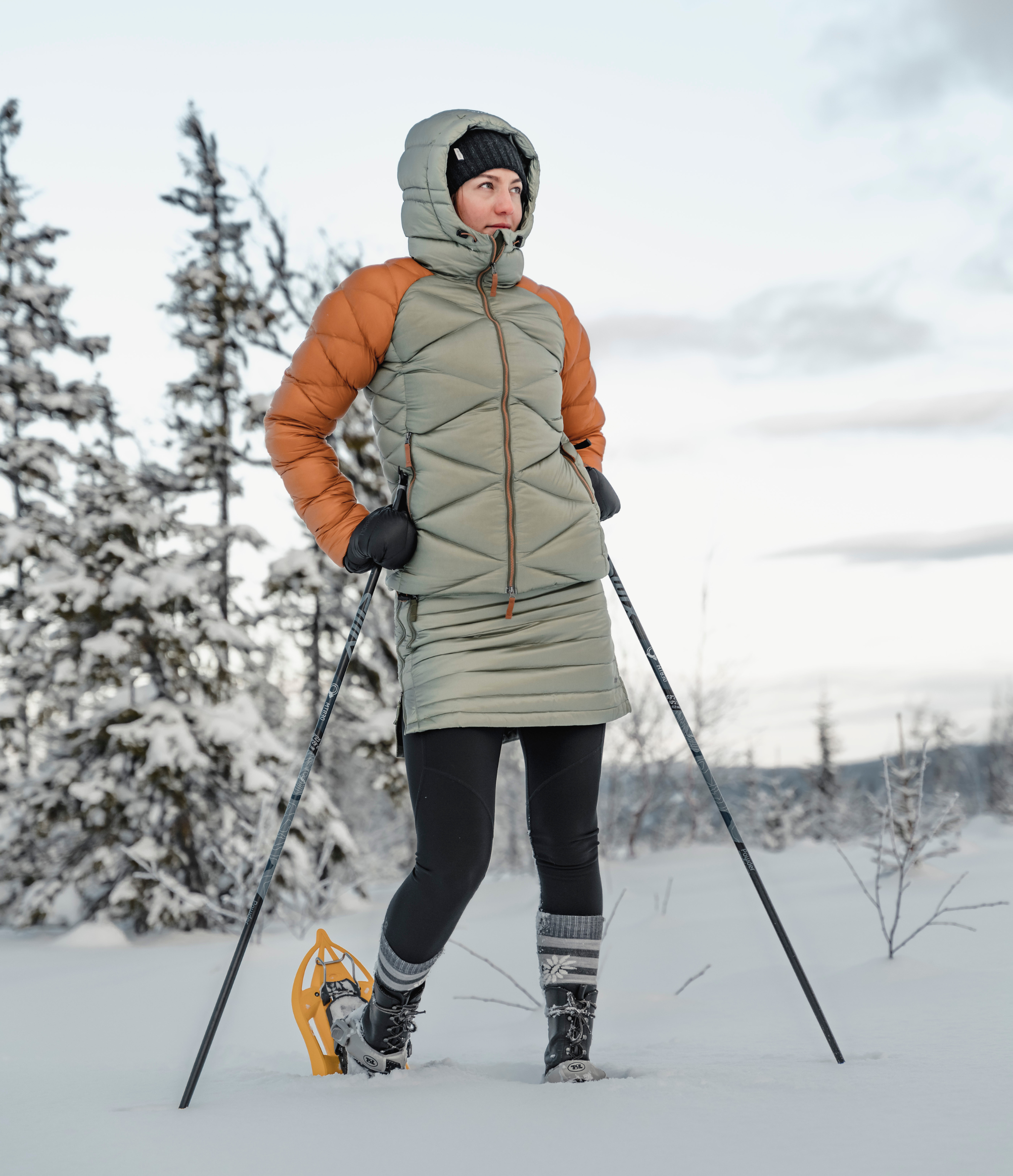woman hiking the snowy forest in skhoop snow skirt