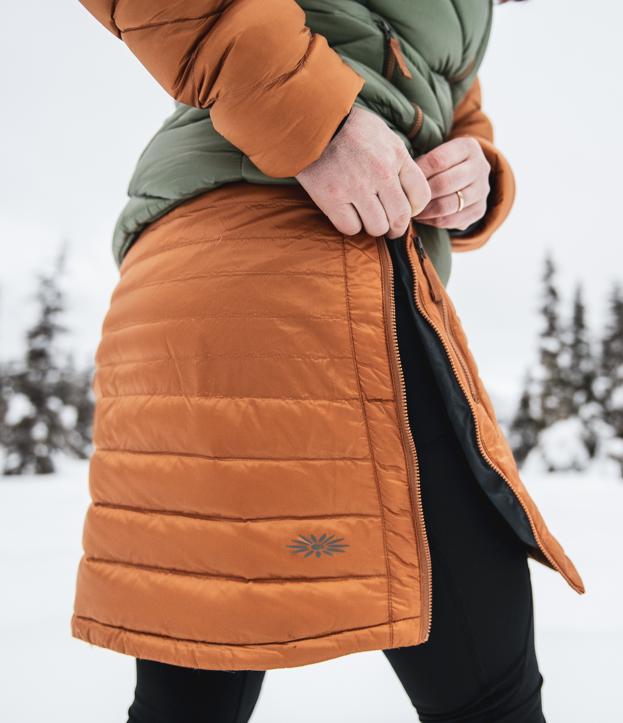 woman pulling down side zipper on skhoop miranda down skirt